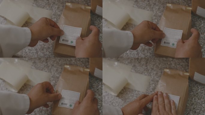 男性双手在面粉包装上贴贴纸的特写