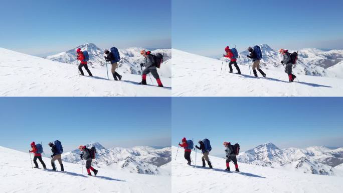 一支成功的登山队正在冬季高海拔雪山山顶的山脊上连续攀登