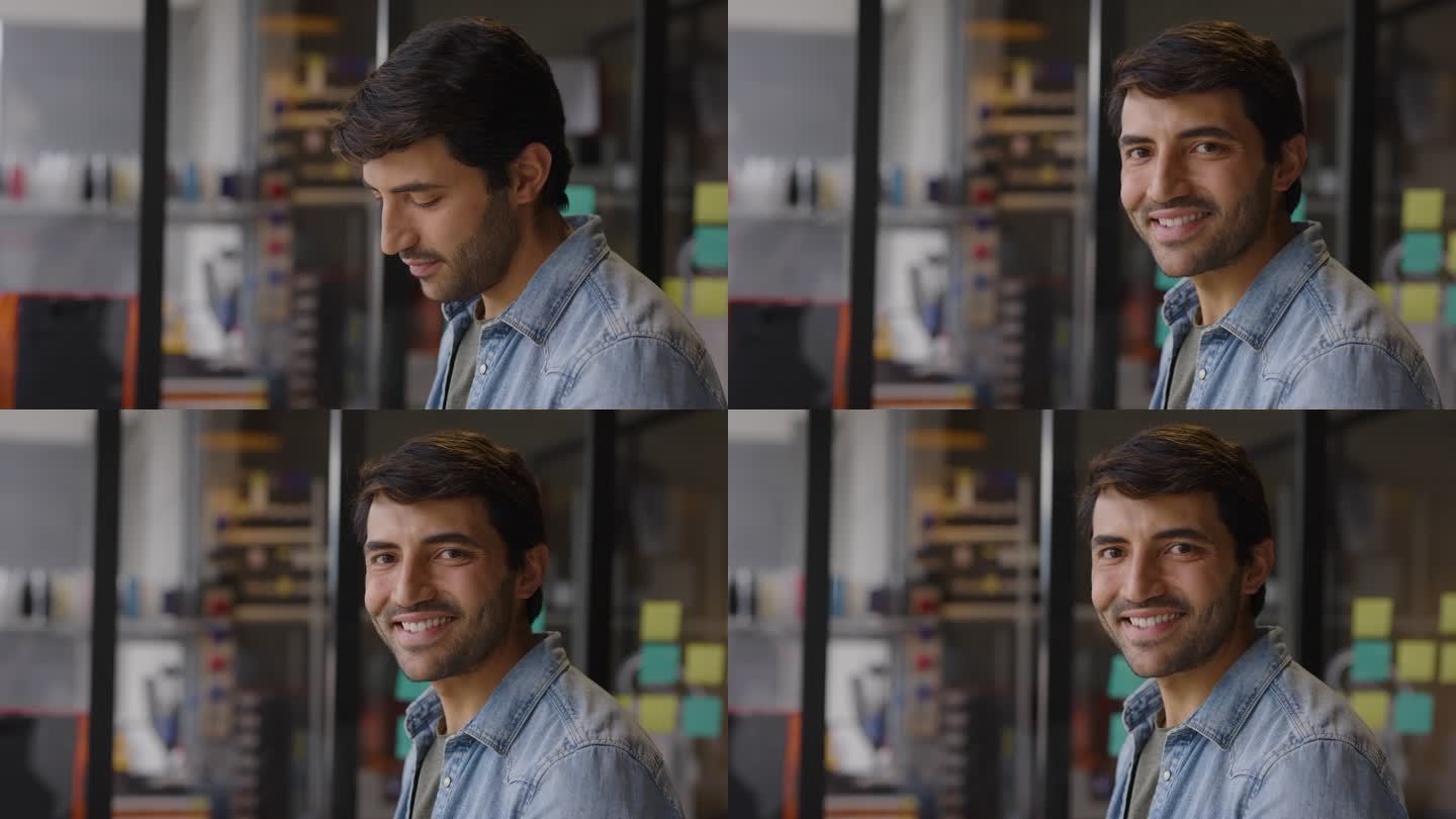 一个快乐的拉丁美洲人在创意办公室工作，看着相机微笑的视频肖像