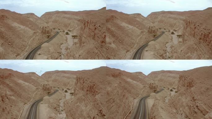 公路上的美景，驾驶汽车在岩石峡谷结构、沙漠山脉和飞鸟之间穿梭