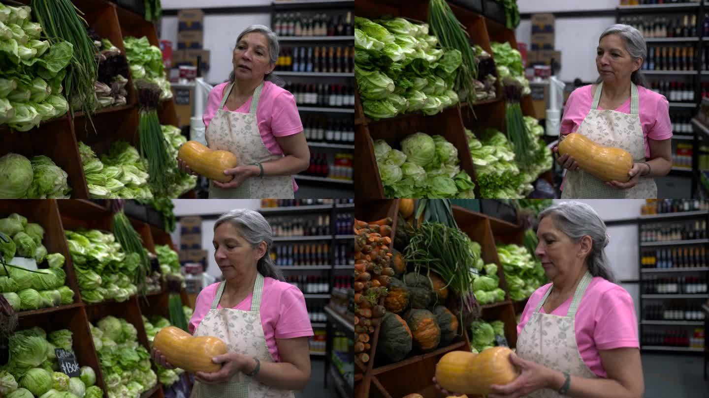 一位在蔬菜水果市场工作的高级女士正在安排展示