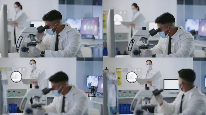 一名戴着口罩的男性科学家在一家医学研究机构中观察显微镜并分析样本。科学实验室的研究人员正在进行新冠病