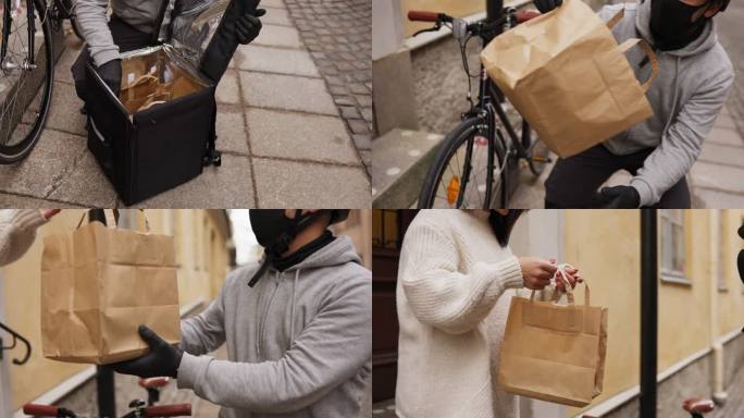 一名妇女从自行车送货员那里收到食物