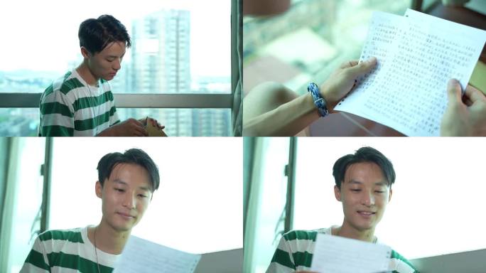 男生在窗边看信件感动