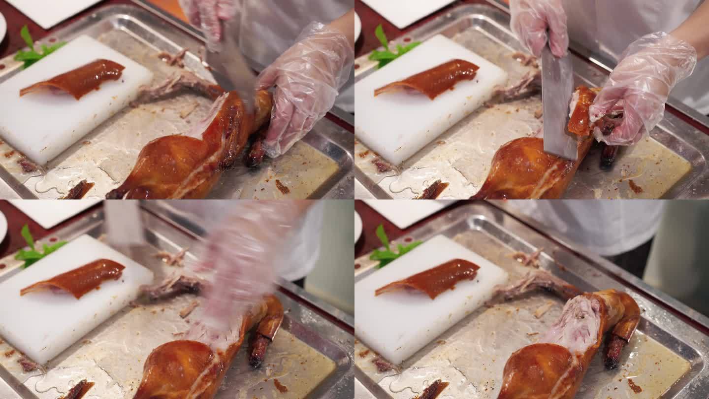 厨师在案板上切北京烤鸭