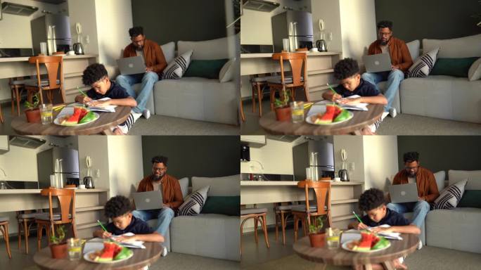 男孩和父亲一起学习，在家做背景工作