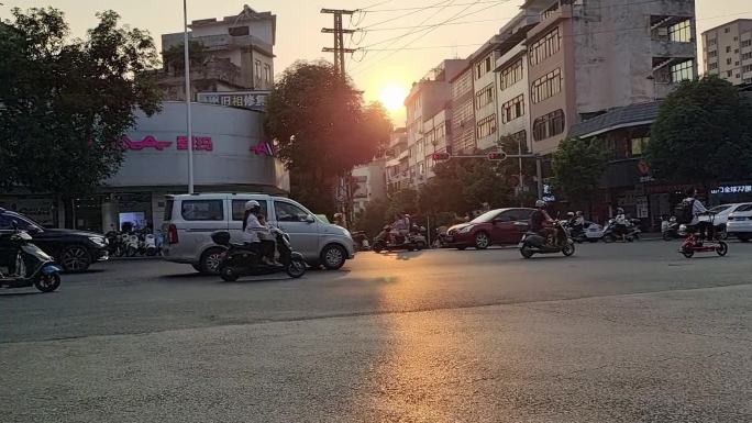 夕阳西下落日黄昏上下班人群摩托车电车大军