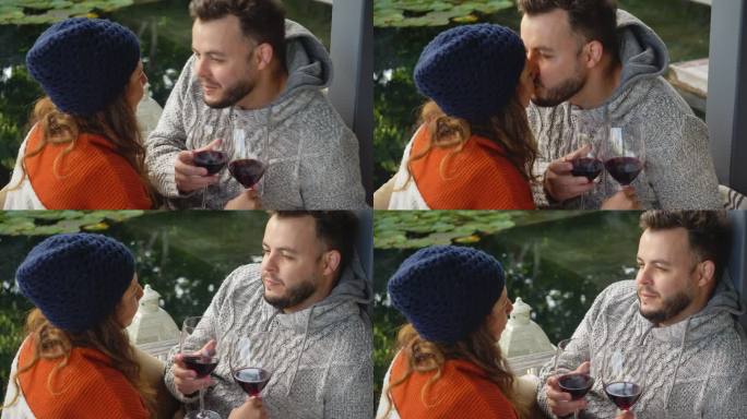 情侣们喝着红酒，在院子里亲吻