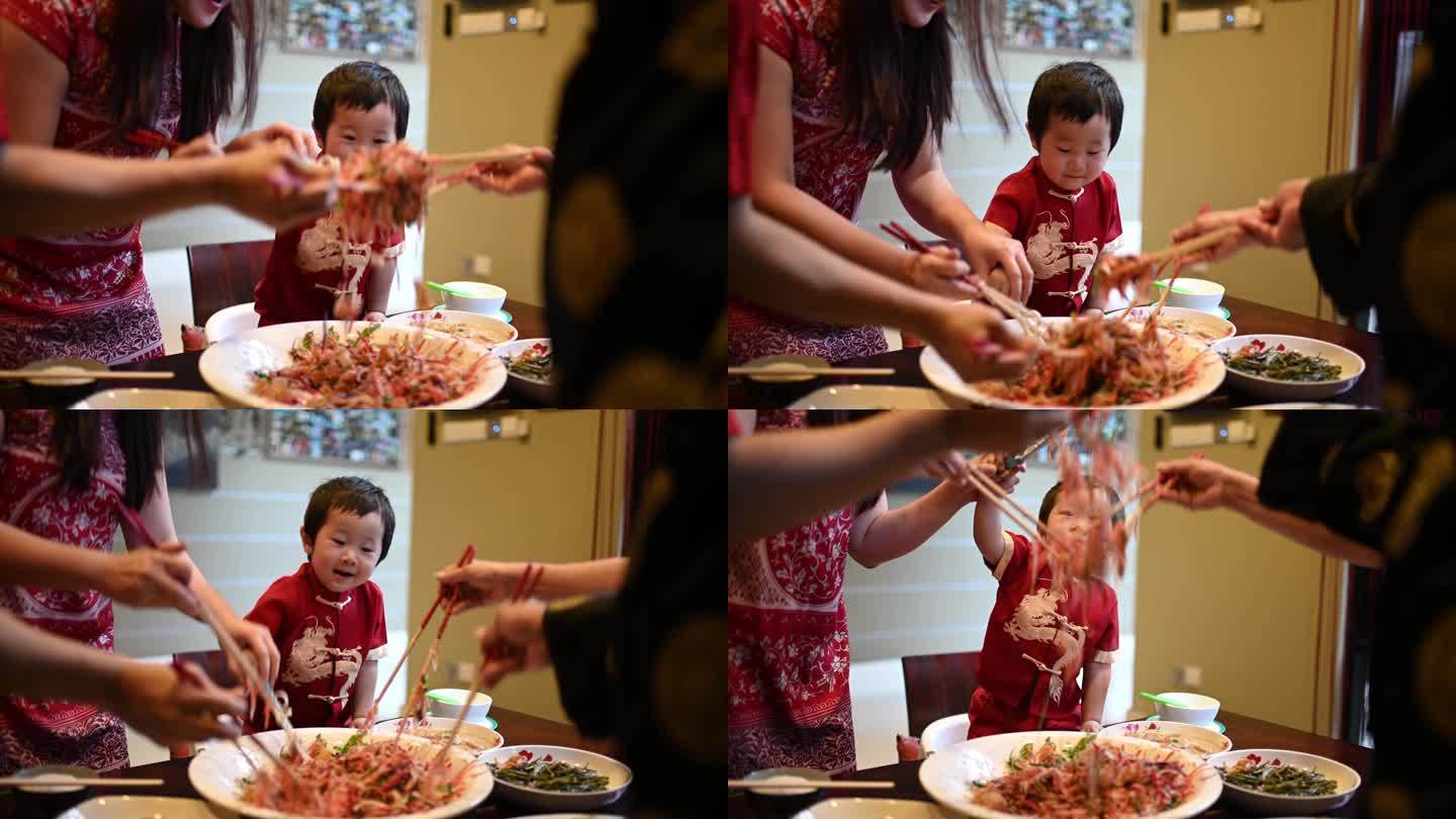 亚洲华人家庭中国新年团圆饭吃传统菜生鱼刘桑