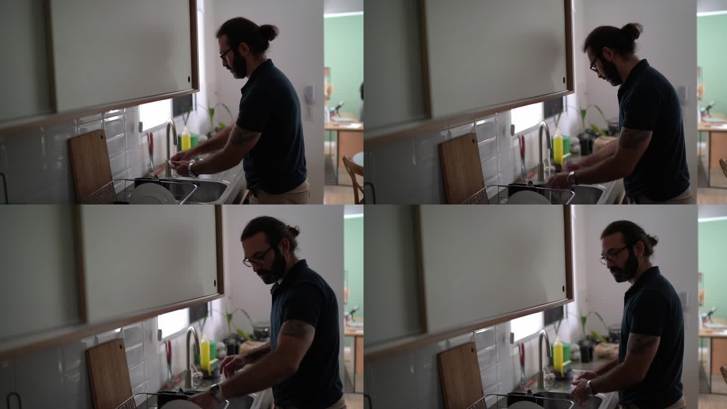 一位成年男子在家洗碗的肖像