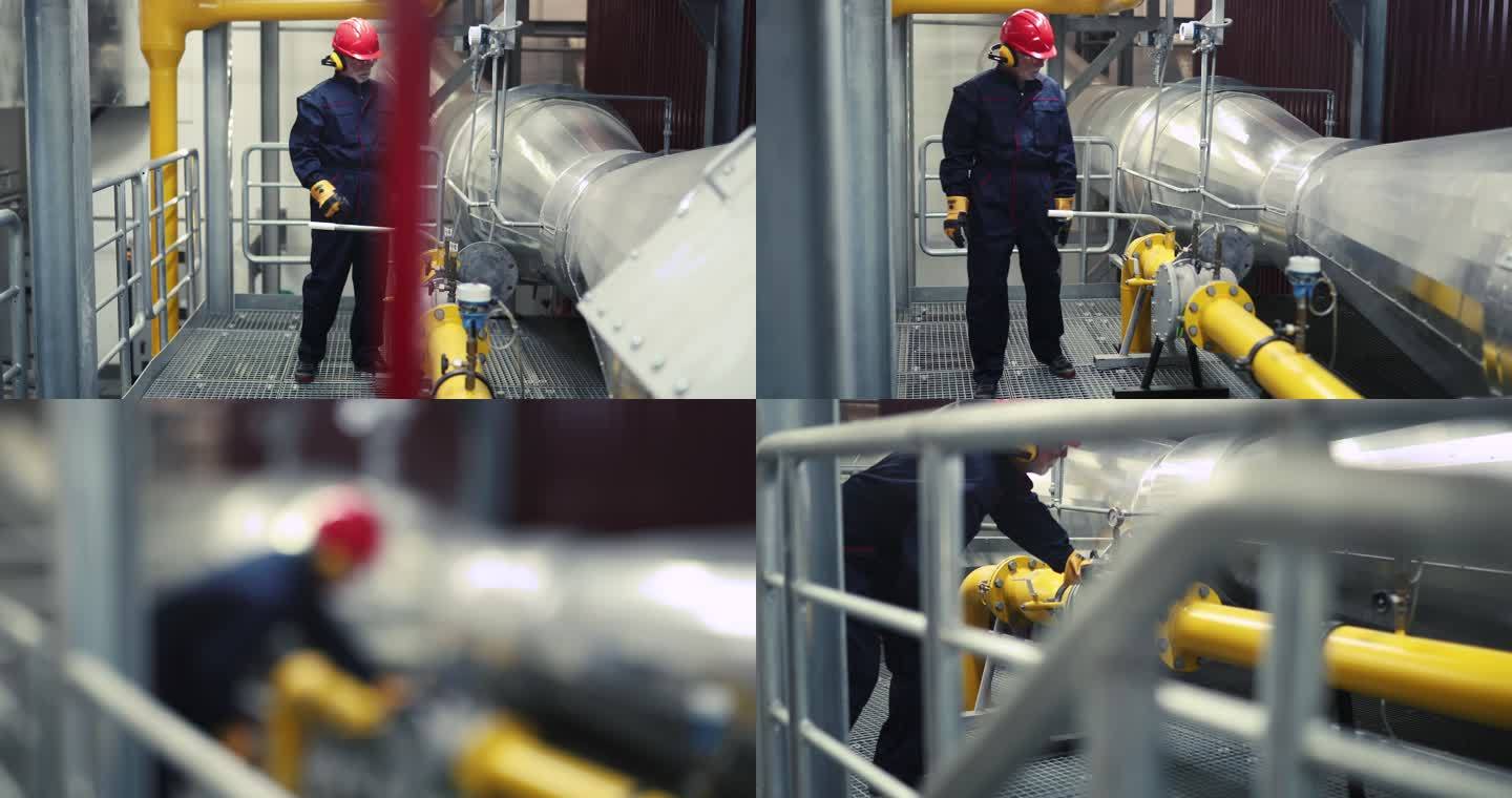 在检查供暖厂管道的运行时，工人戴着对讲机。