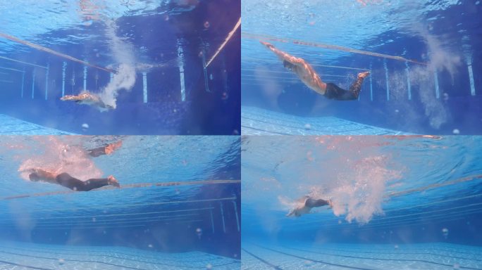 水下低视角亚洲中国男子游泳运动员在游泳池蝶泳