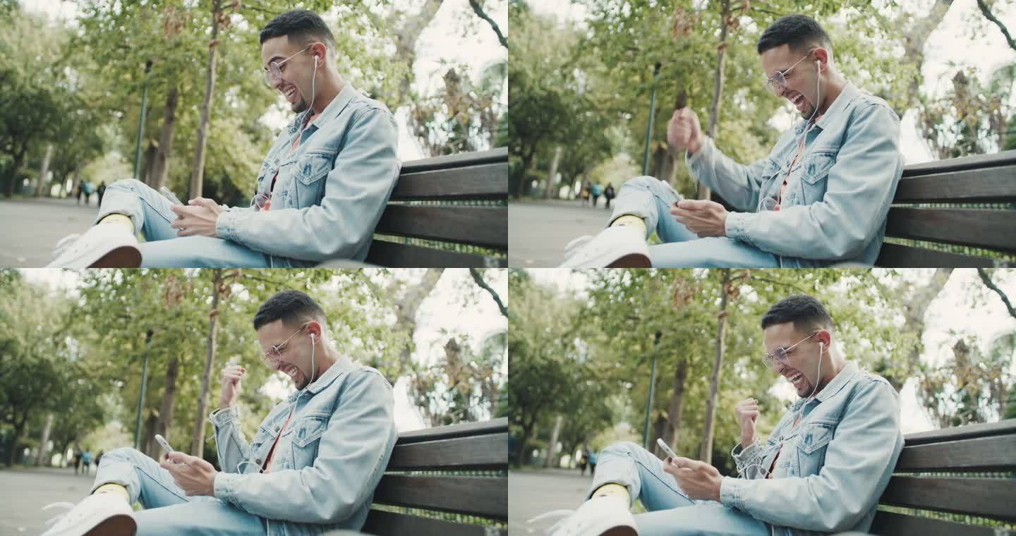 一个年轻人在公园的长凳上放松时，用带耳机的智能手机庆祝的4k视频片段