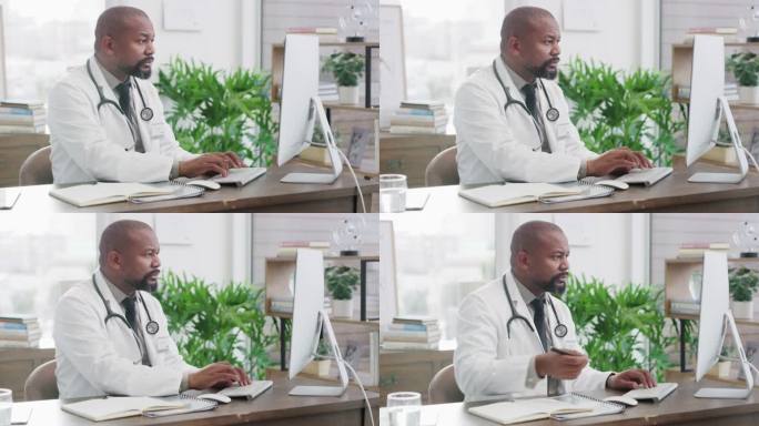 一名成年男性医生在医院办公室使用电脑的照片