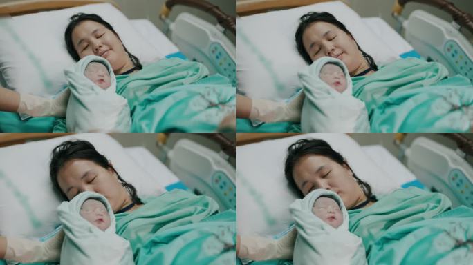 亚裔母亲和她的婴儿在医院的产房出生。