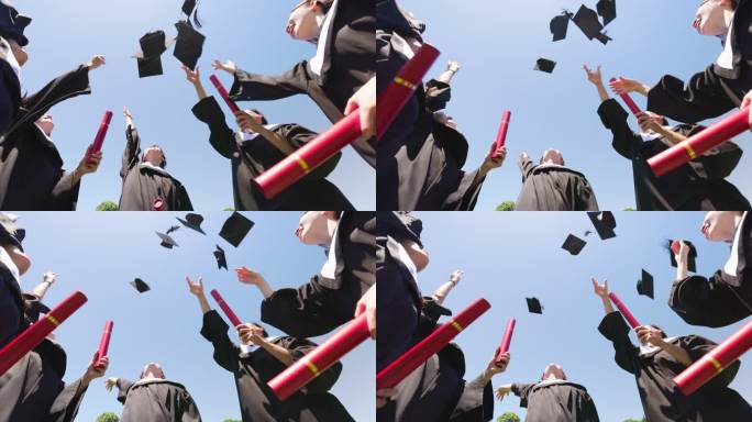 一群快乐的毕业生投掷帽子