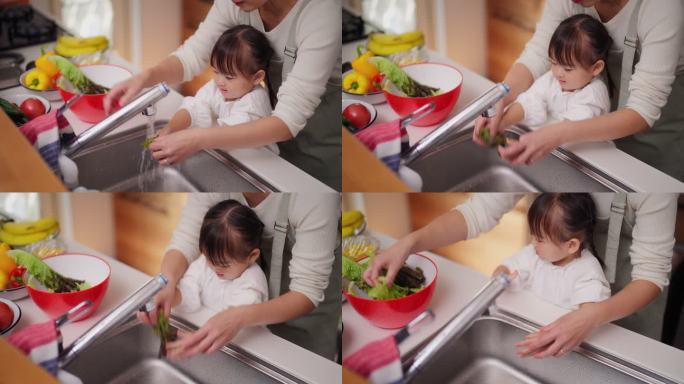 母亲帮助小女儿洗蔬菜，鼓励她健康饮食
