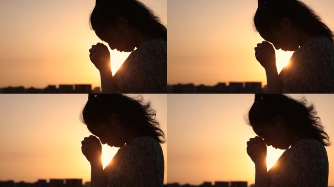 女人在阳光下祈祷阳光逆光祈祷祷告