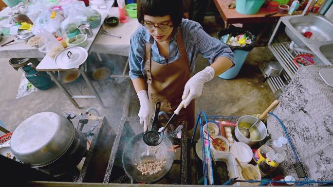 街头厨师在家中或街头厨房烹饪热菜