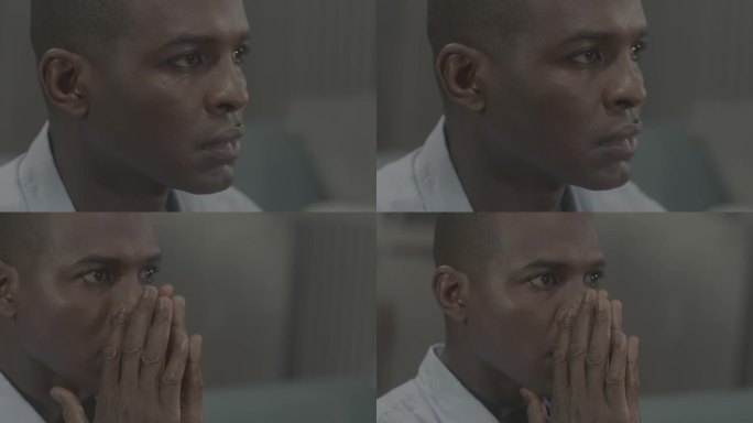 非州男人黑人熬夜看电视惊讶害怕祈祷睁大眼