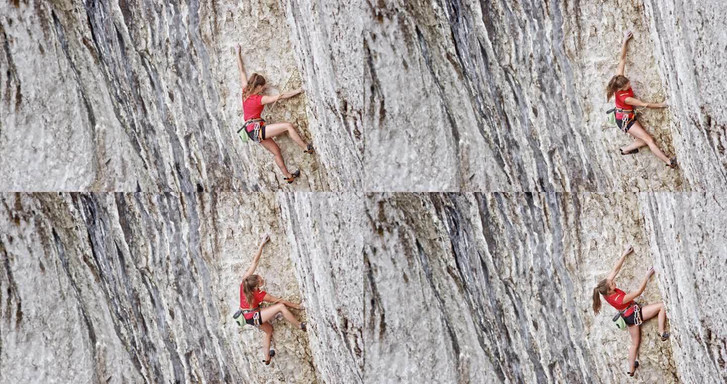 穿着红色衬衫的女性攀登者攀登悬崖