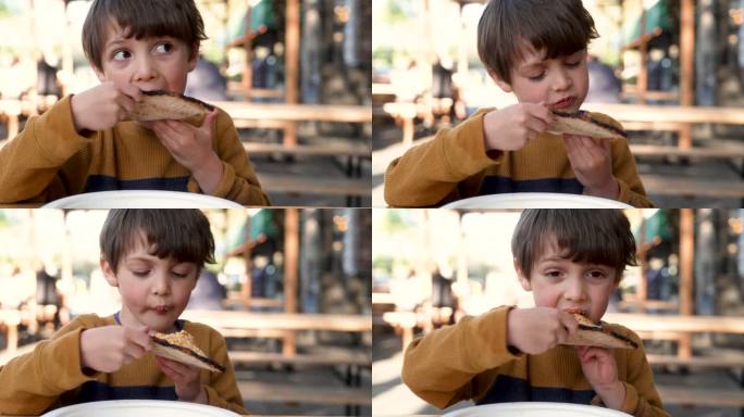 小男孩吃一片披萨小男孩吃一片披萨