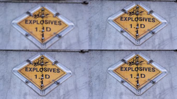 建筑工地用螺栓固定在钢墙上的“炸药1.1 D”标志的正面镜头