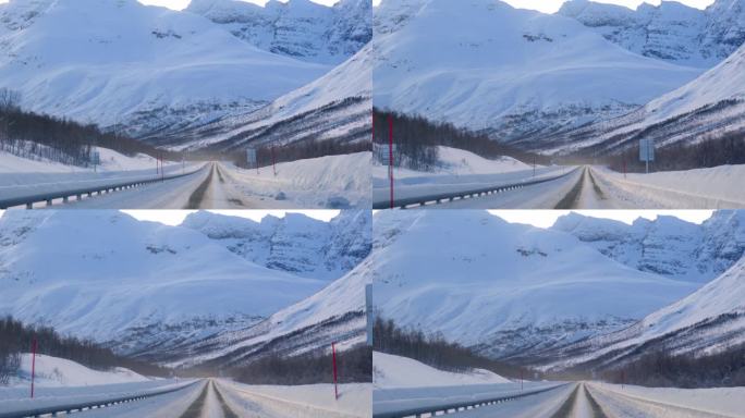行驶在北欧雪山下的沥青公路