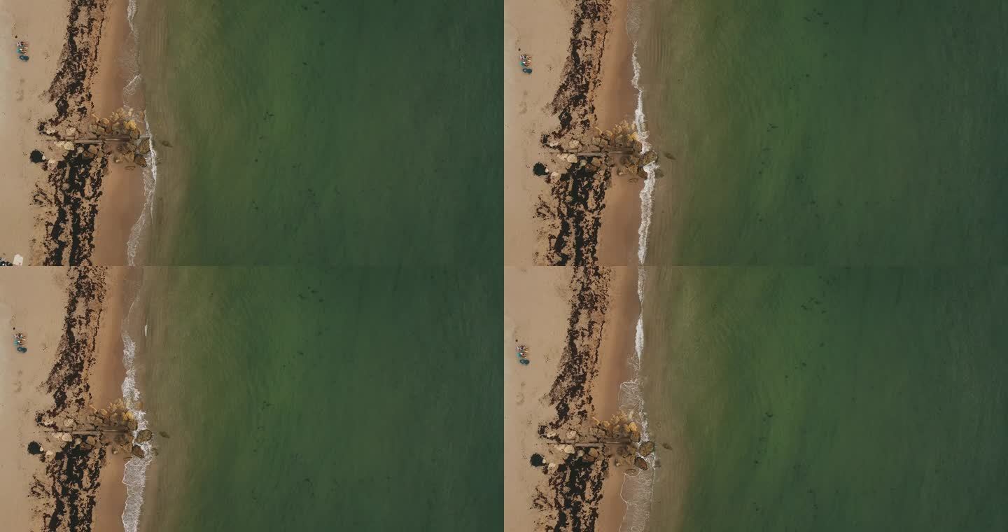 2022年6月25日，佛罗里达州棕榈滩金色云雾晨曦中，蓝绿色海浪席卷海岸的空中无人机画面