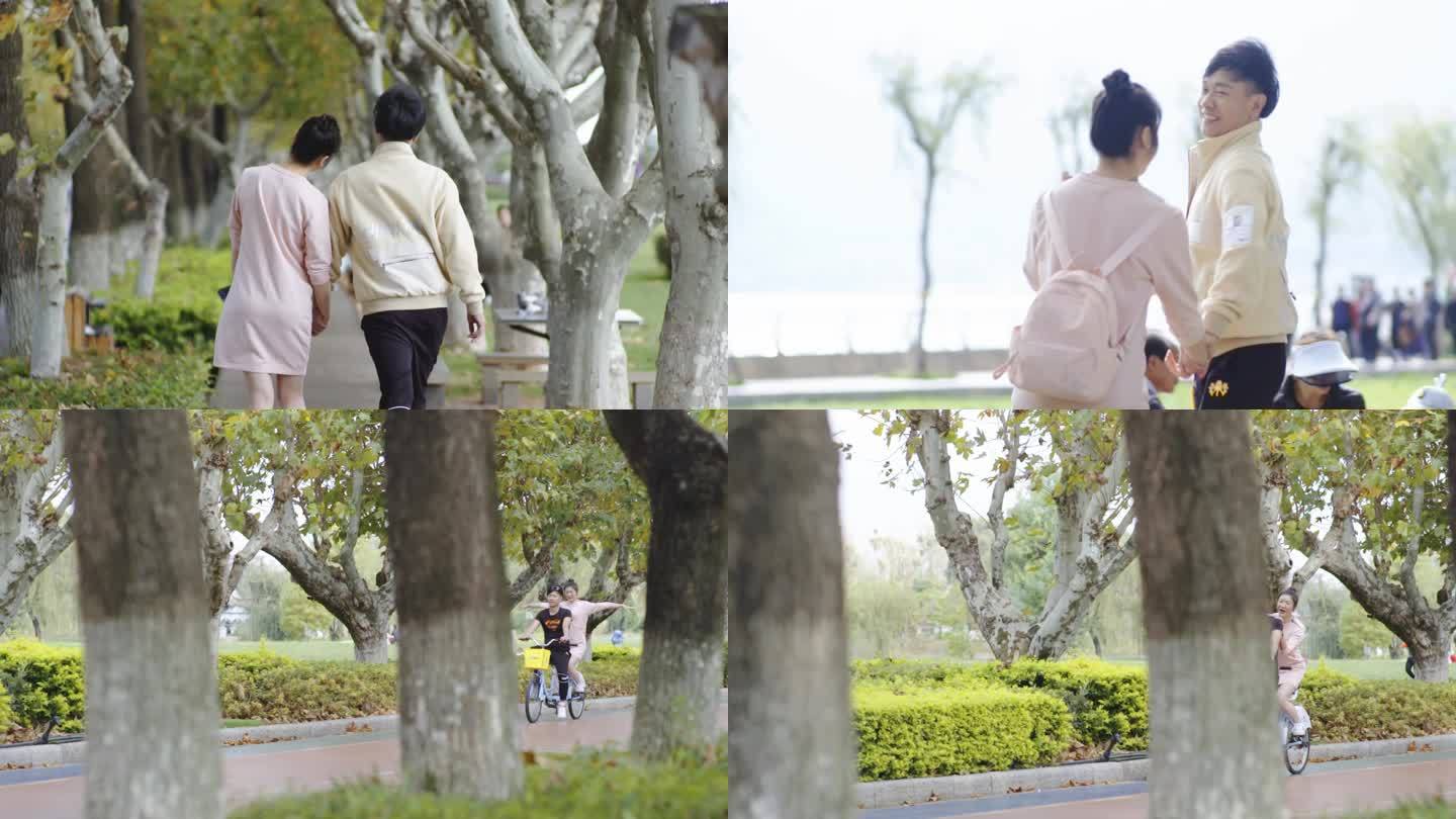 情侣公园约会 夫妻公园牵手散步 骑自行车