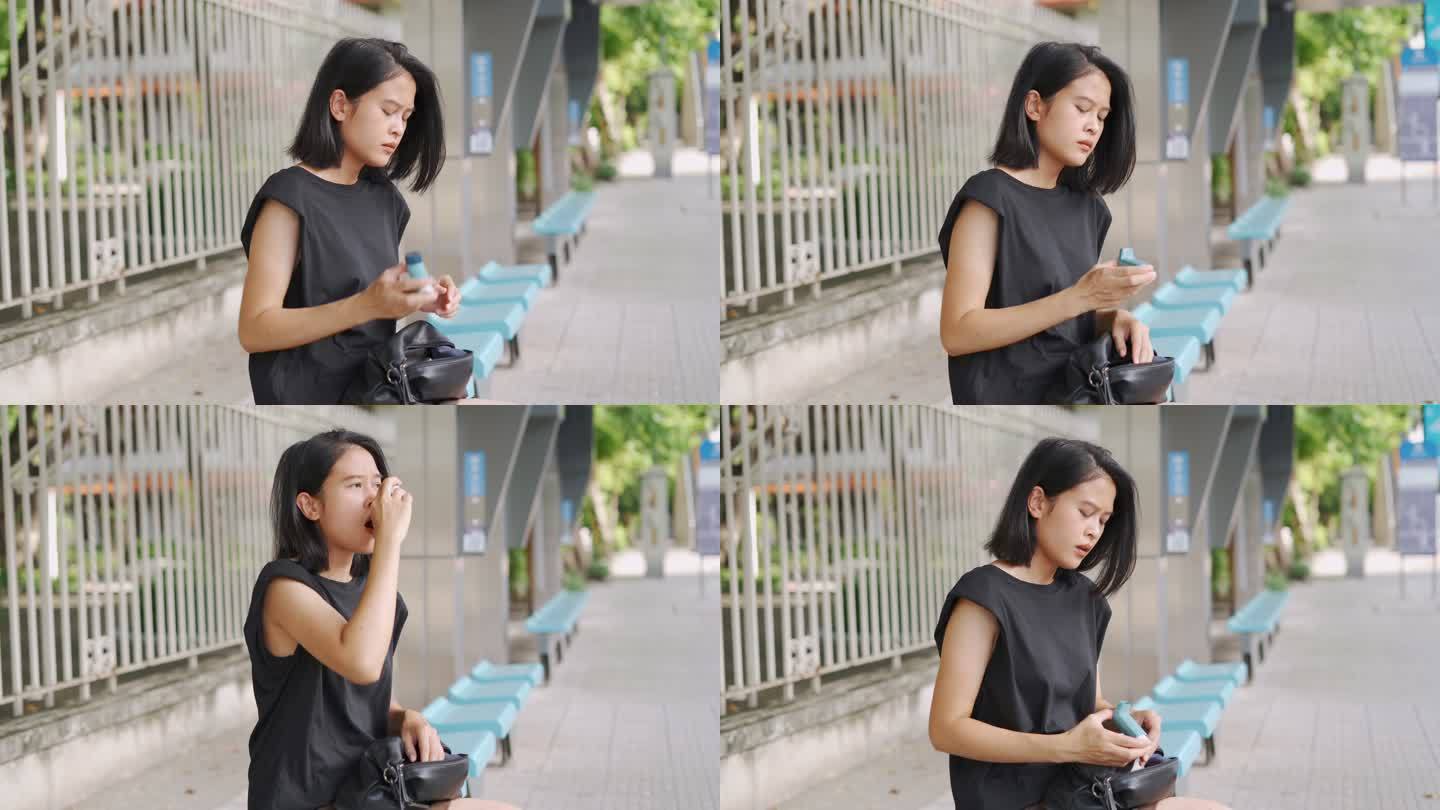 在公共汽车站使用哮喘吸入器的亚洲女性