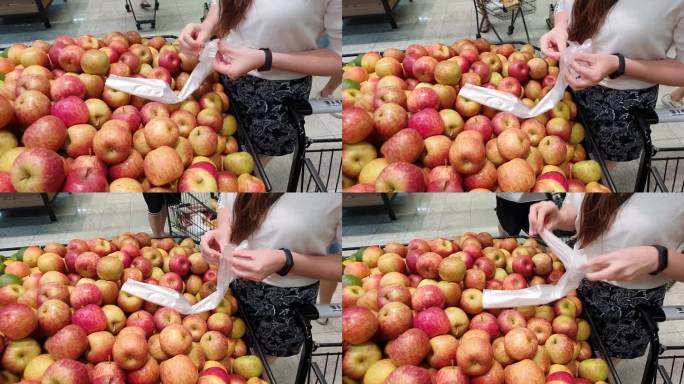 女人在超市购物时选择苹果