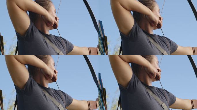 一名年轻女子射箭运动员在射箭场练习射箭的4k视频片段