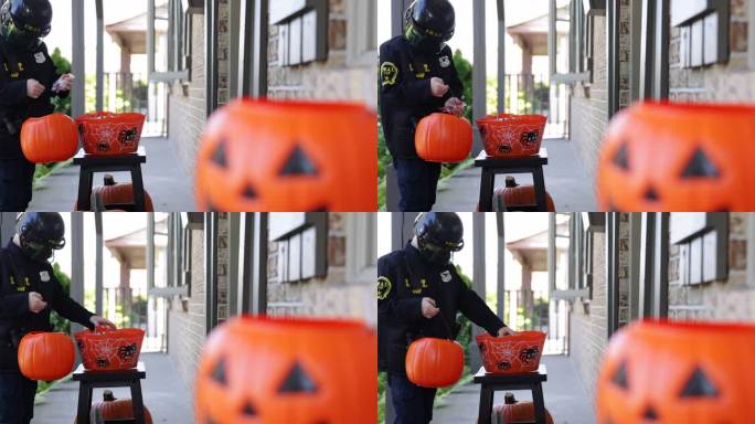 在万圣节，穿着防护面罩和警官服装的男孩正在吃糖果