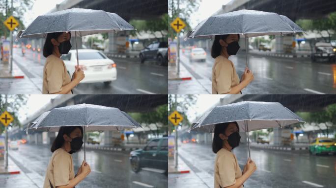 在雨中等待出租车的亚洲女性
