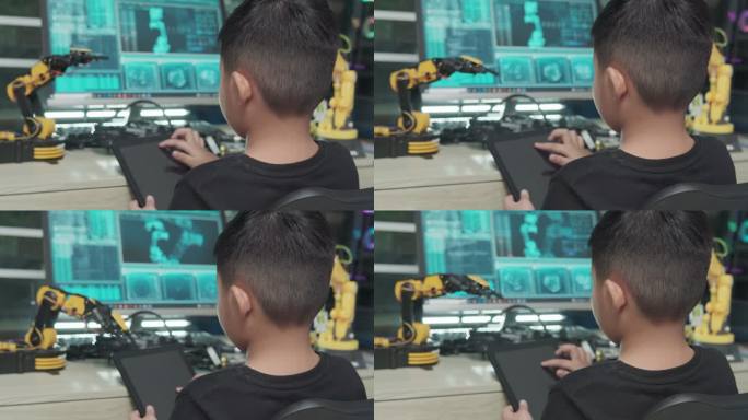 教育主题：数字平板电脑上的男孩控制机器人手臂、科学工程、教育、技术