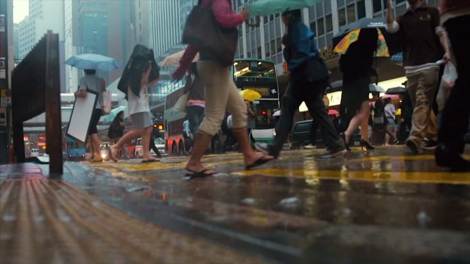 雨中的香港街城市街道大雨中的行人匆忙的脚