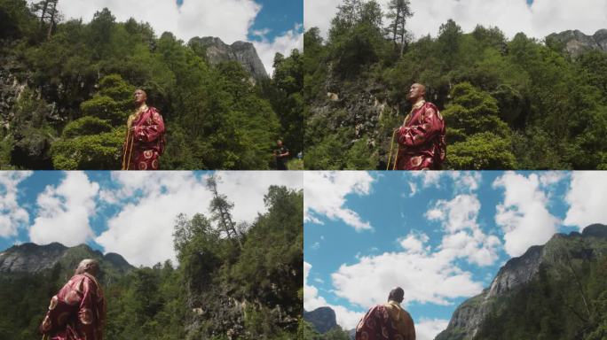 藏族喇嘛看蓝天白云下群山环绕