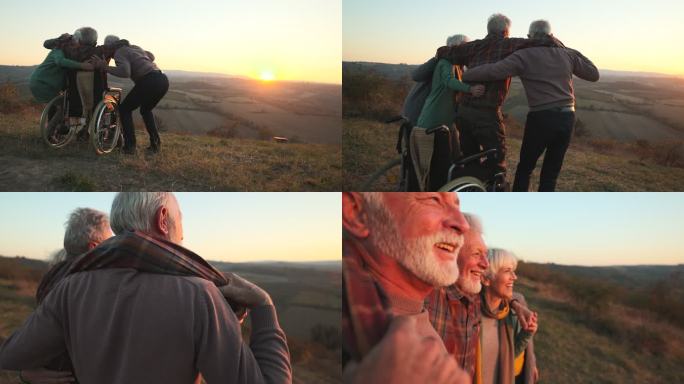一群老年人帮助他们的残疾朋友和他们一起站着欣赏风景。
