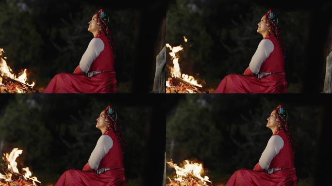 火堆旁赏夜的藏族女子