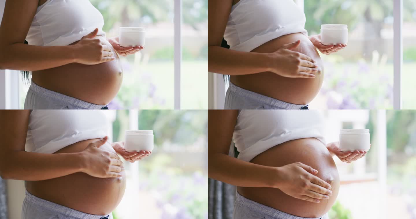 一名孕妇在腹部涂抹润肤霜的4k视频片段