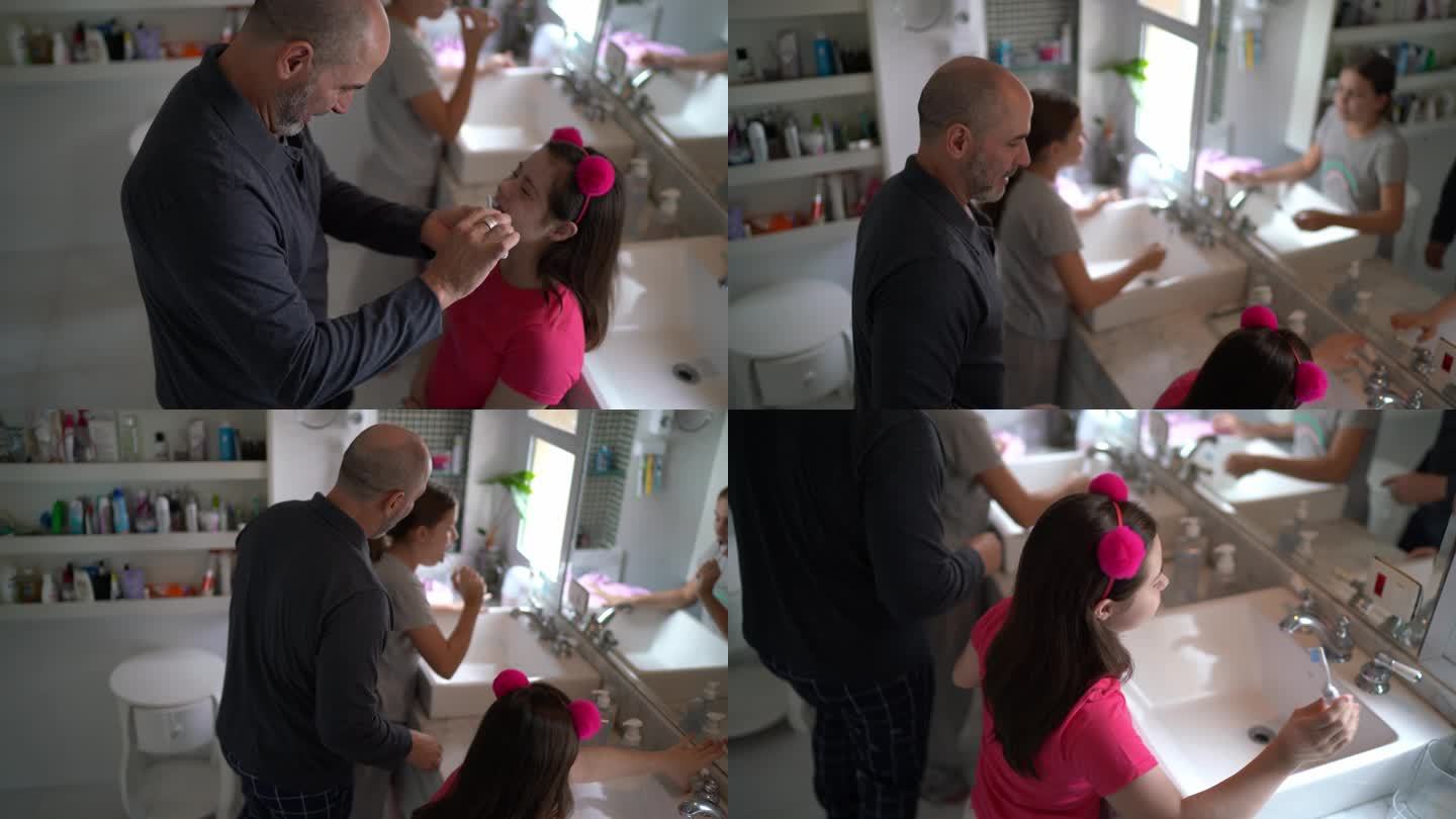 父亲早上在家帮女儿刷牙，包括一个特殊需要的女孩