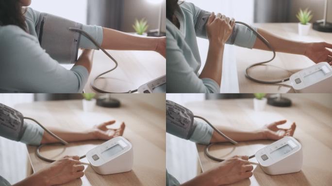 亚洲女性用数字血压仪测量自己的血压