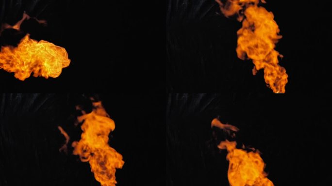 黑色背景上的火焰。色彩对比度高。火焰在左侧，底部垂直且成角度。慢动作。