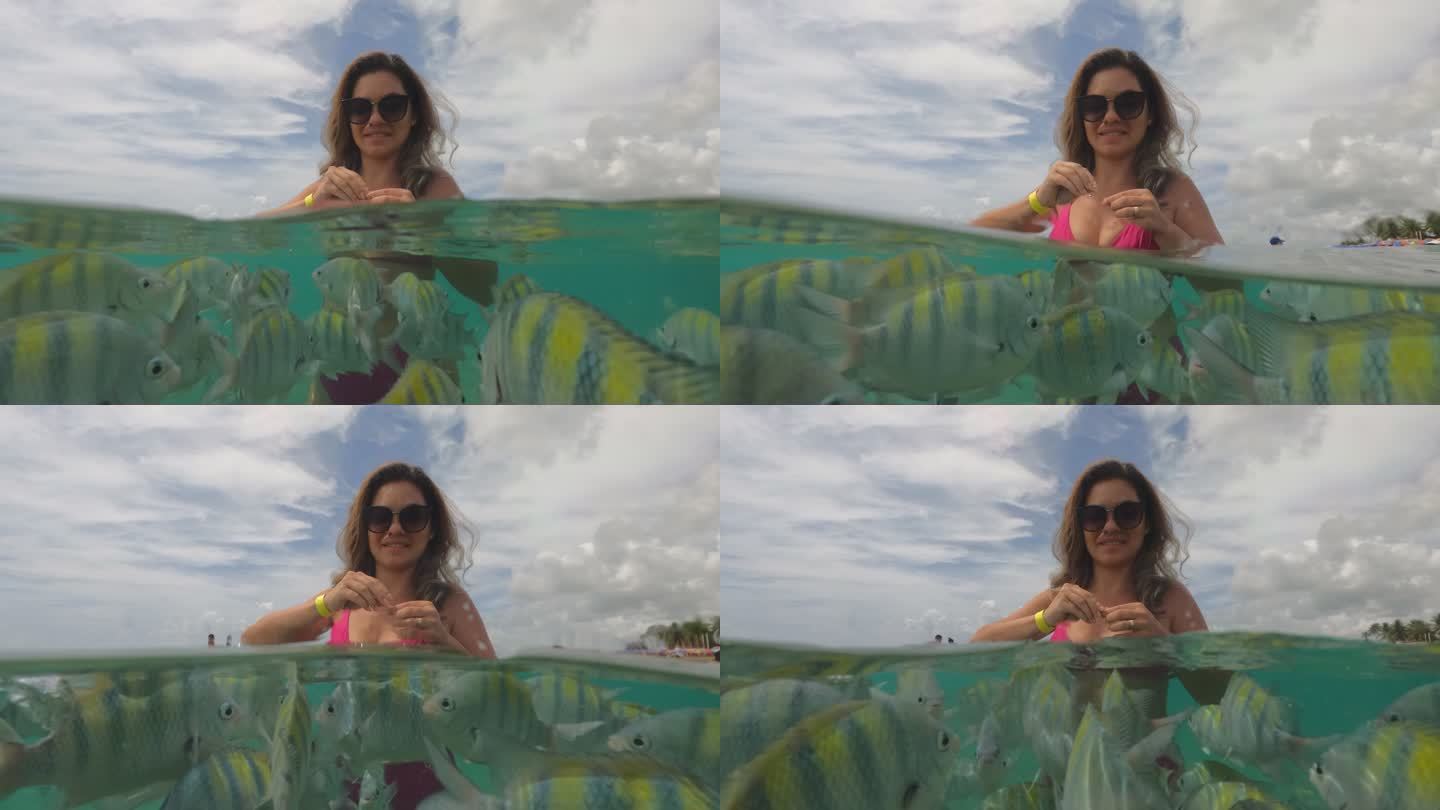 在热带海滩喂鱼的女人