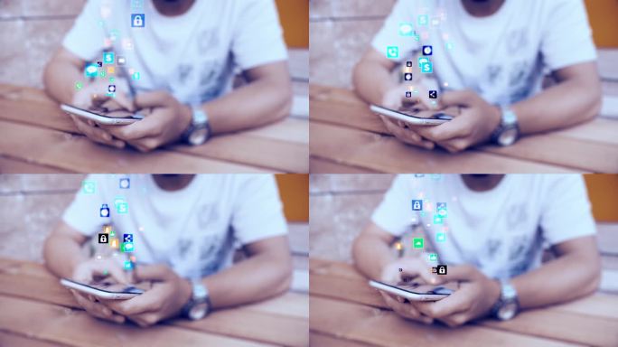 使用智能手机发送表情符号的男子。手机旁边有各种表情符号和社交网络的图形图标。
