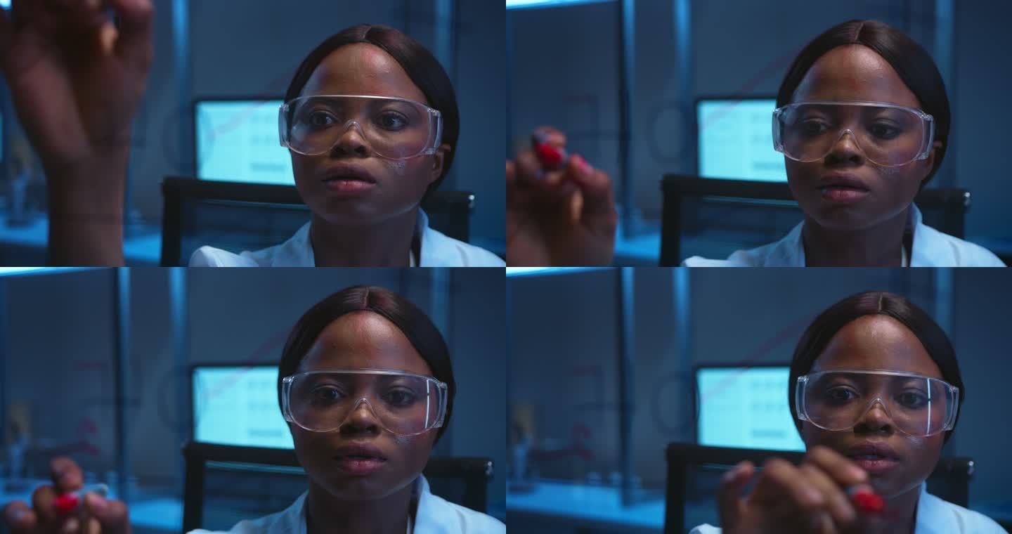 一位年轻美丽的非洲裔美国科学家在现代实验室的玻璃板上写公式
