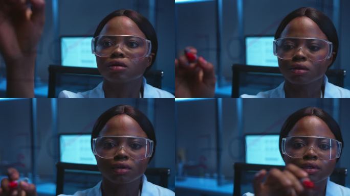 一位年轻美丽的非洲裔美国科学家在现代实验室的玻璃板上写公式