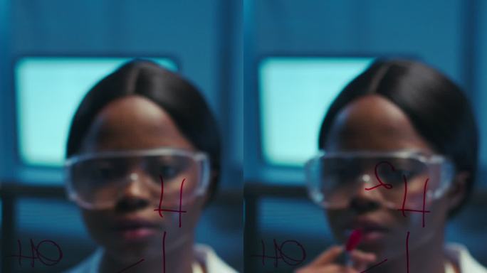一位年轻体贴的非裔美国科学家身穿白色实验服，在玻璃板上写下化学配方
