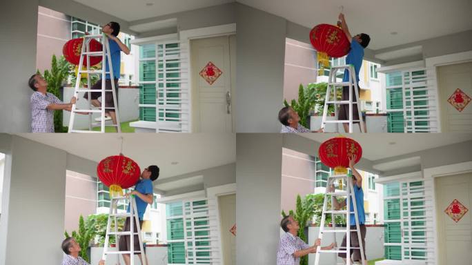 除夕夜，亚裔中国父亲在家前院给儿子递红灯笼